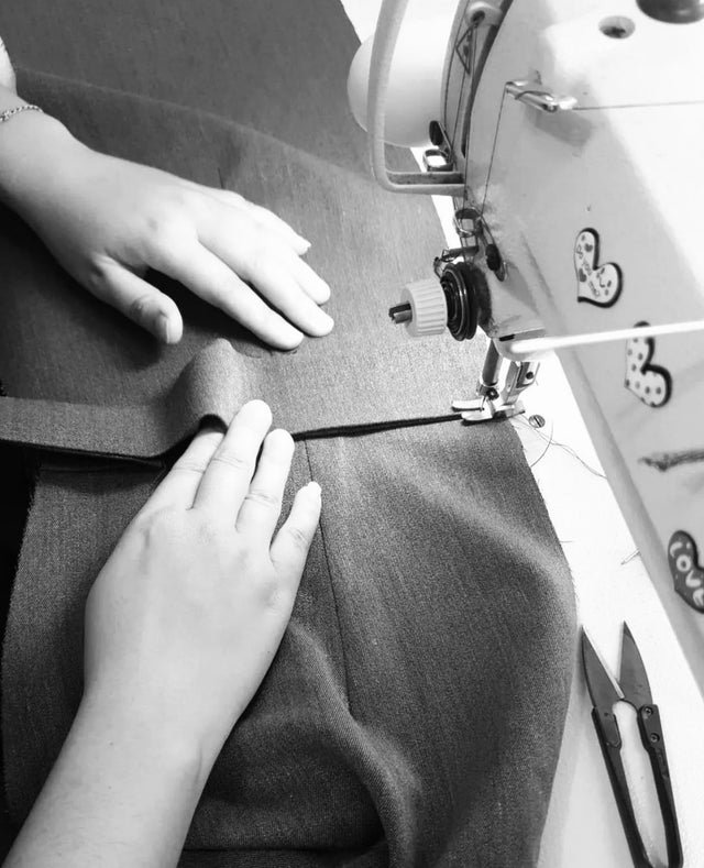 woman sewing clothes with sewing machine